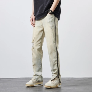 Men's vintage distressed denim jeans with full-length side zippers and ripped details