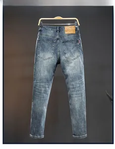 Detail of slim fit denim jeans featuring leather patch and classic back pocket embroidery