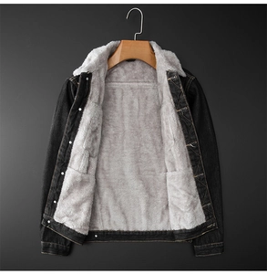 Detail of warm grey fleece lining and metal buttons on a dark denim winter jacket