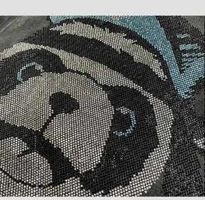 Macro detail of rhinestone panda pattern on high-quality black denim jacket fabric