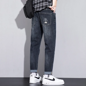 Men's dark blue stretch slim denim jeans with street style back pocket print and rolled cuffs