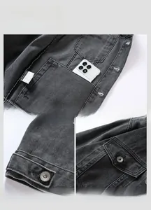 Detailed view of dark grey denim jacket featuring reinforced pockets and metal buttons