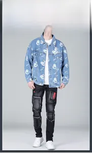 Detail of light blue denim jacket with bear print and distressed patched black jeans