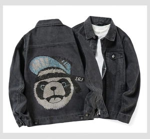 Detail of black denim jacket featuring a sequined panda with a blue hat on the back