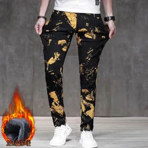 Men's slim fit black denim pants with yellow splatter pattern and warm fleece lining