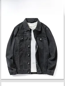 Detail of black denim jacket featuring washed texture and classic metal button pockets