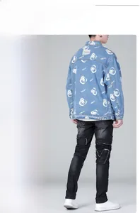 Macro detail of cartoon bear print and metal buttons on oversized light blue denim jacket