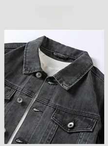 Close-up of deep grey denim jacket featuring high-quality stitching and metal buttons