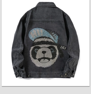 Detail of street-style charcoal black denim jacket with rhinestone panda design on back