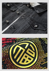 Detailed macro view of colorful rhinestones and gold Fu character on black denim jacket