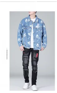 Detail of light blue denim jacket with teddy bear print and patched black jeans