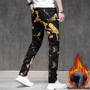 Men's slim fit fleece jeans featuring bold yellow abstract print for winter warmth
