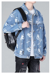 Detail of light blue denim jacket with bear graffiti prints and drop shoulder design