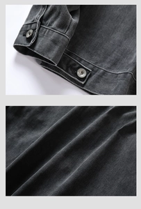 Detail of dark gray denim jacket showing buttoned cuffs and twill fabric texture