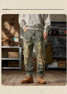 Detail of vintage loose jeans featuring distressed holes and ethnic stripe fabric patches
