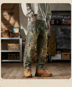 Detail of vintage distressed blue denim jeans featuring heavy ripping and plaid patch repairs