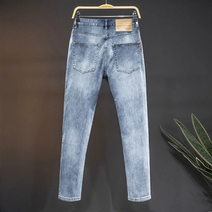 Slim fit light blue washed straight denim jeans for men with vintage whiskering effect