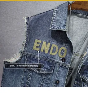 Detail of vintage washed denim vest with ENDO embroidery and raw edge sleeves