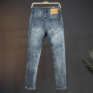 Slim fit dark blue men's jeans with vintage wash effect and classic embroidery detail