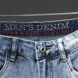 Men's blue slim fit denim jeans with washed texture and 1983 waist embroidery