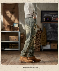 Detail of distressed vintage green denim with heavy rips and white paint splatters