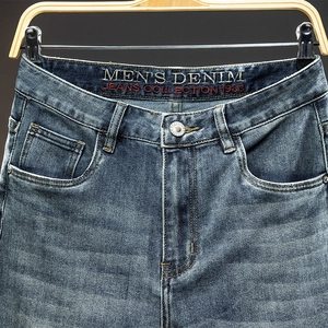 Men's slim straight denim jeans with vintage wash and premium metal button detailing