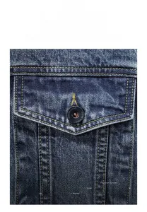 Detail shot of vintage denim jacket showing sturdy alloy buttons and neat pocket stitching