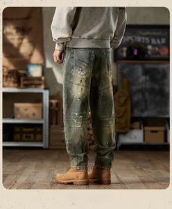 Detail of vintage washed denim with paint splatter effects and knee pleats for men