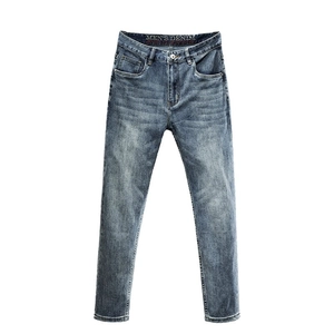 Men's slim straight leg jeans in mid-blue wash with authentic faded whiskers and five pockets