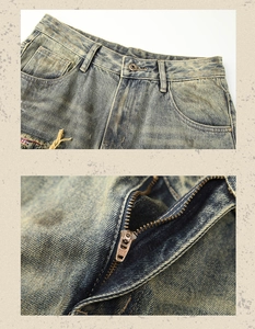 Detail view of the YKK zipper and distressed vintage denim texture on loose jeans