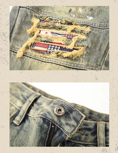 Detail of vintage distressed denim featuring star patterns and metal 1979 jeans buttons