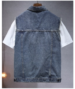 Detail view of denim vest back featuring industrial stitching and adjustable hem button