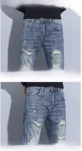 Detailed macro view of vintage distressed denim jeans with button and ripped texture