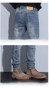 Detailed close-up of vintage distressed jeans rear pocket and hem with leather patch