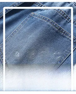 Detail of blue denim shorts showing heavy cotton fabric texture and yellow stitching