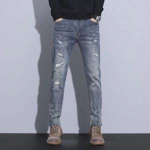 Slim fit men's distressed jeans with blue wash and white paint splatter details