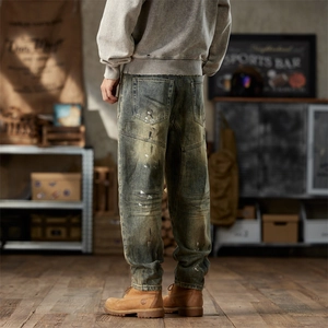 Men's vintage distressed baggy jeans with paint splatters and yellow mud wash effect