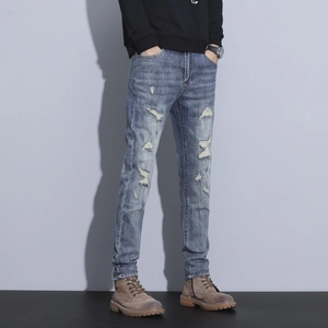 Men's retro slim fit distressed denim jeans with ripped details and faded blue wash finish
