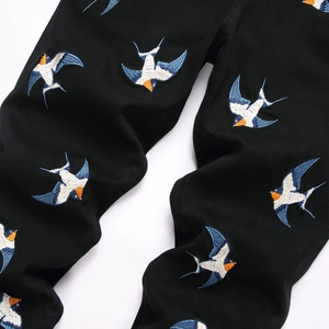 Men's slim stretch black denim jeans with colorful swallow bird embroidery patterns