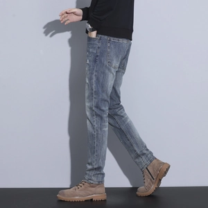 Slim fit men's distressed blue washed denim jeans with ripped details and casual style