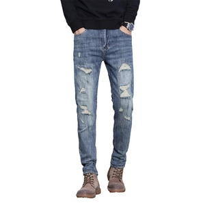 Slim fit men's distressed blue denim jeans with vintage wash and ripped knee details