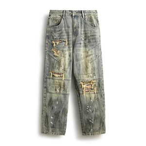 Retro loose-fit distressed jeans for men with vintage wash, patches and paint splatters