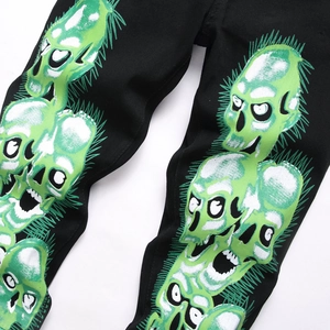 Jeans streetwear gothique avec grand imprimé tête de mort vert et blanc sur denim noir