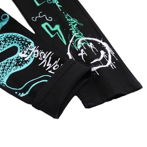 Men's slim black denim jeans featuring vibrant graffiti prints and dragon scale patterns