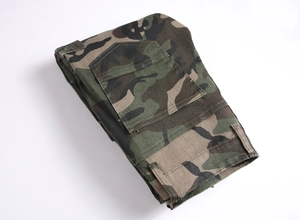 Detailed view of durable cotton cargo pants featuring classic jungle camouflage pattern