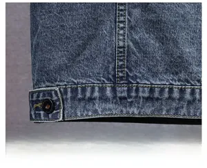 Close-up of washed blue denim vest hem with yellow stitching and black button