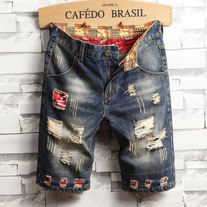 Men's loose distressed denim shorts with vintage wash and red plaid patchwork details