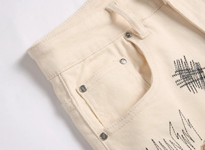 Macro shot of off-white denim pocket with black wave embroidery and jeans metal rivets