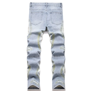 Men's slim fit distressed jeans in light blue featuring unique yellow sunburst embroidery