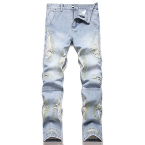 Distressed slim straight jeans in light blue wash with yellow radial embroidery detail
